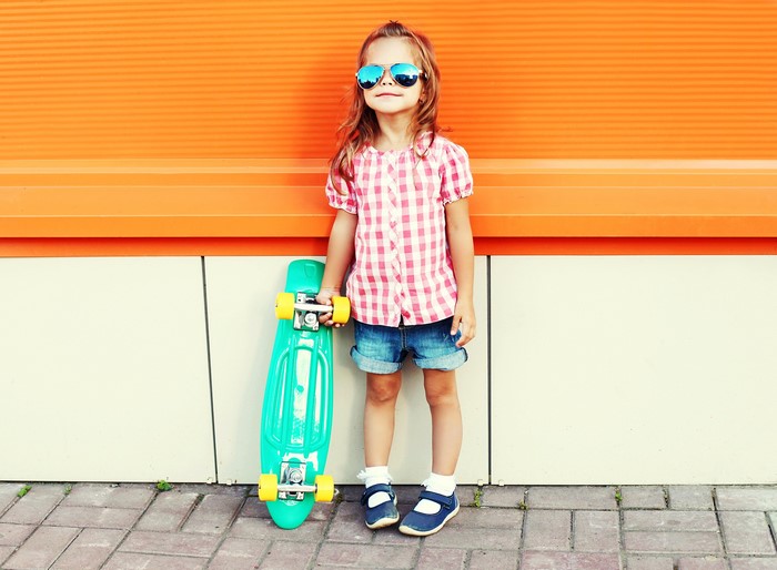 Girl with sunglasses and skateboard