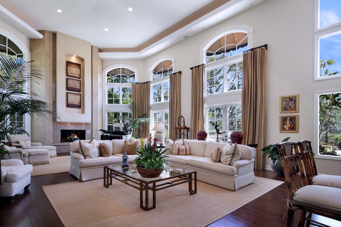 Living room with sofas, piano, and fireplace