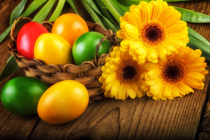 Easter Eggs in Wicker Basket with Yellow Gerberas