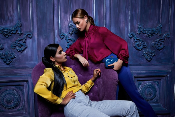 Two women in formal shirts and pants