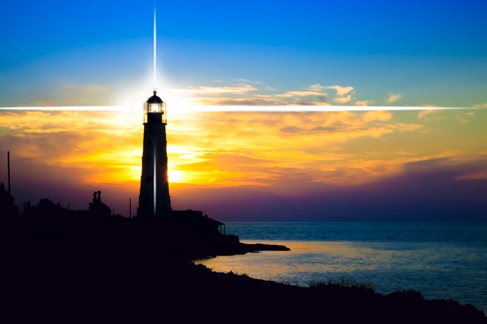 Lighthouse at Sunset over the Sea