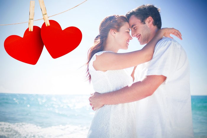 Couple in love on beach with hearts
