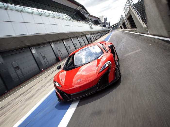 Red McLaren 675LT US-spec on a race track