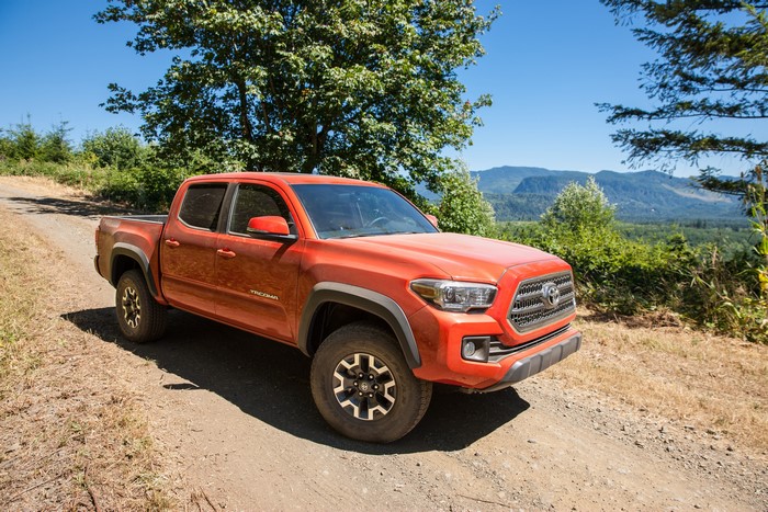 Orange Toyota Tacoma TRD Off-Road on a dirt road