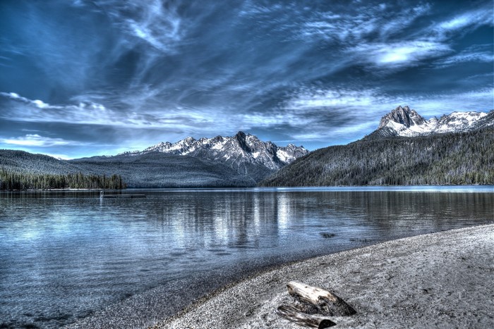 Lake and snow-capped mountains under a cloudy sky