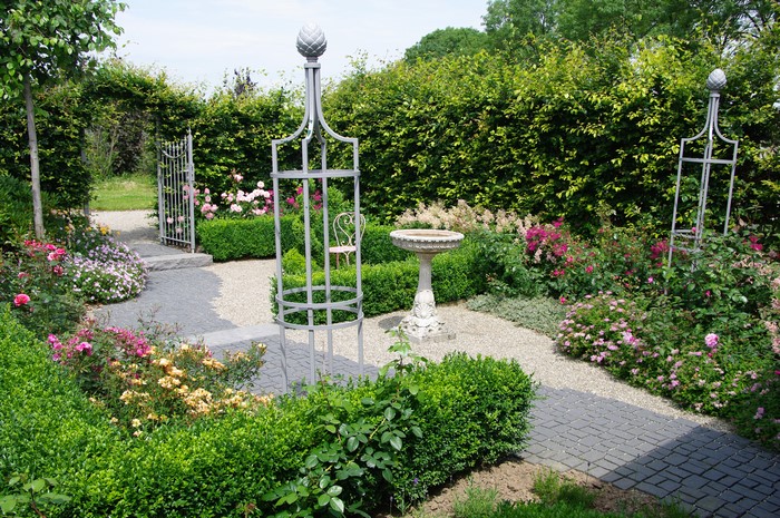 Garden with roses, hedges, and a bird bath
