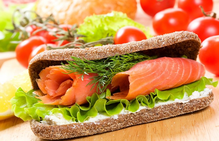 Sandwich with smoked salmon, lettuce, and dill