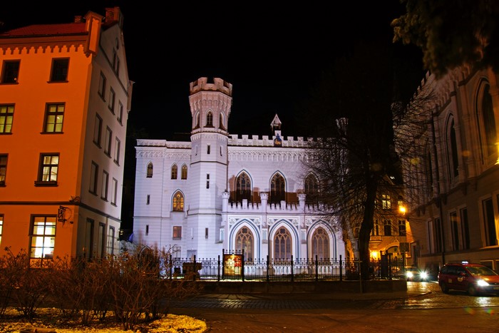 White castle-like building at night in Riga, Latvia