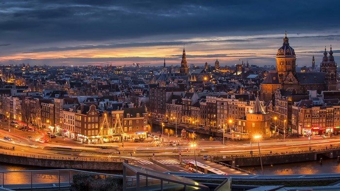 Amsterdam cityscape at dusk with canals and lights