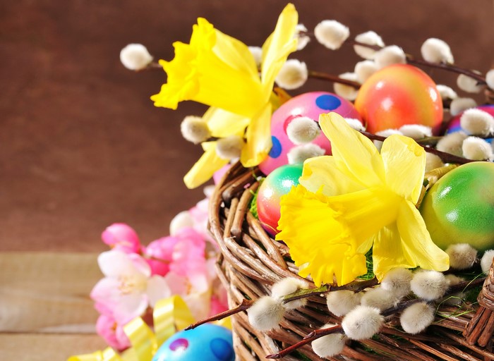 Easter basket with daffodils, pussy willows, and decorated eggs