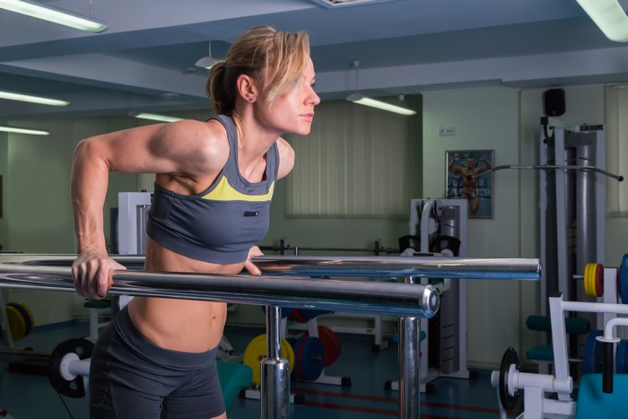 Woman doing dips in a gym