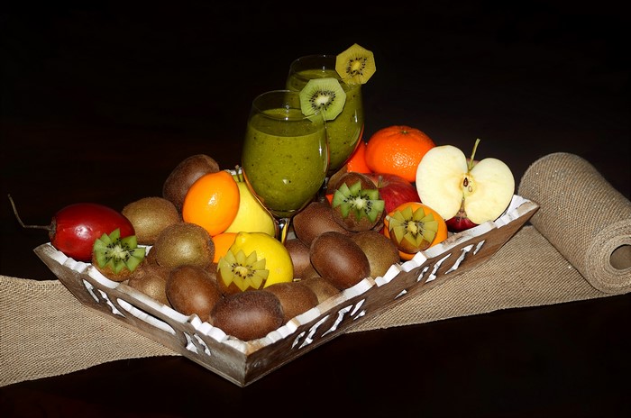 Fruit platter with kiwi smoothies and oranges