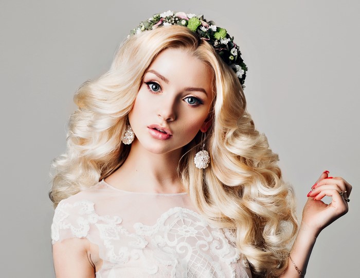 Blonde woman with curly hair and flower crown