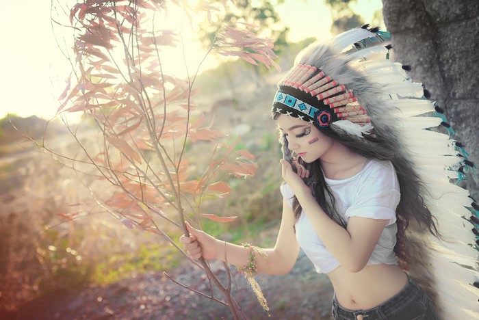Asian woman wearing a war bonnet