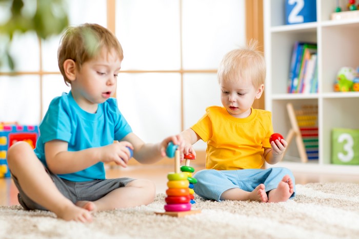 Two young boys playing with toys