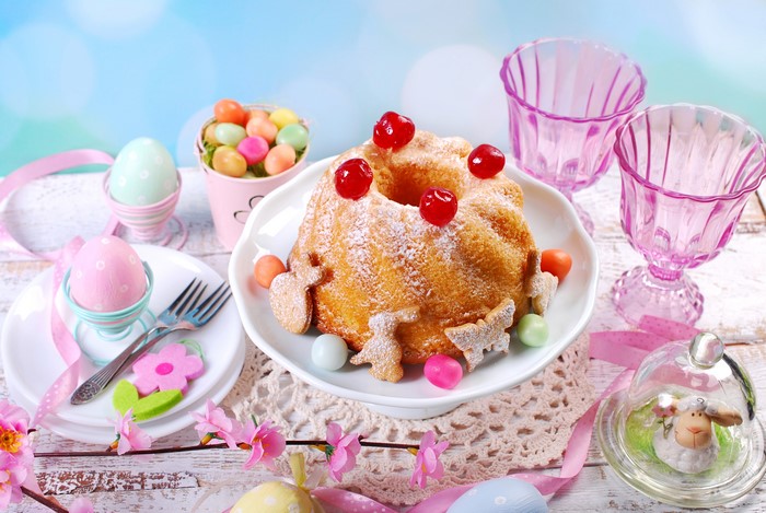 Easter cake with cookies, eggs, and pink glasses