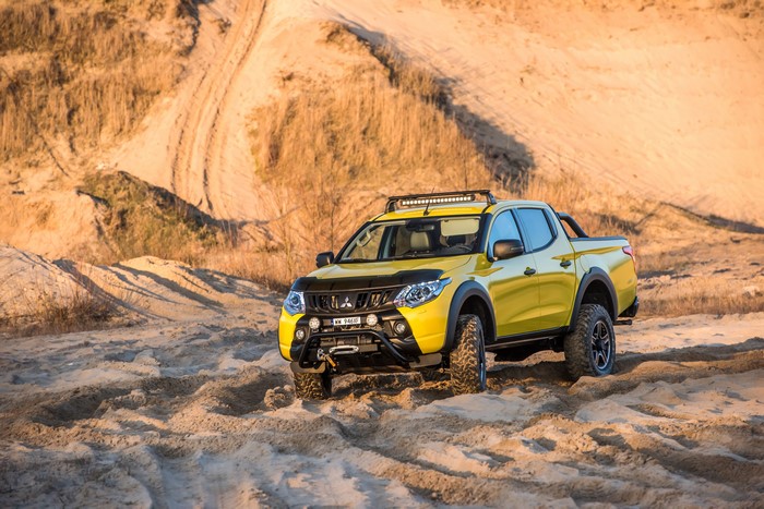 Yellow Mitsubishi L200 Monster Concept off-roading in sand