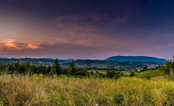 Sunset over rolling hills and fields