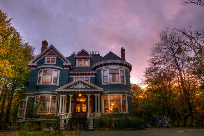 Victorian Mansion at Dusk with Autumn Trees