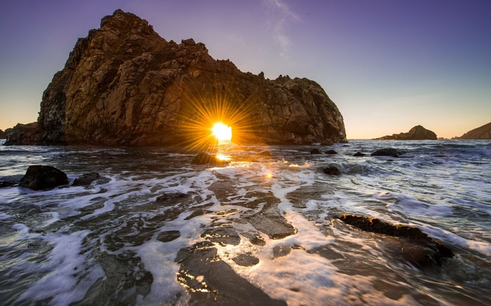 Sunset through rock arch at Pfeiffer Beach