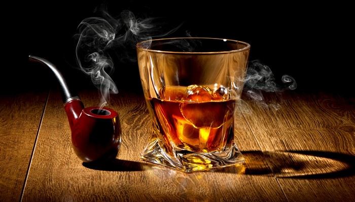 Whiskey and smoking pipe with smoke