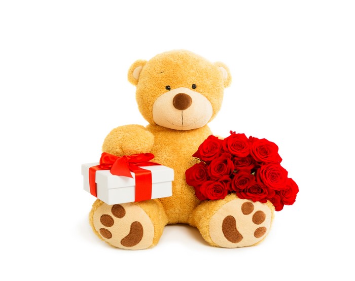 Teddy bear with gift and red roses