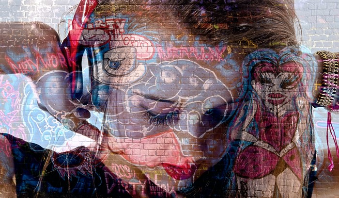 Graffiti on a brick wall with a woman's face