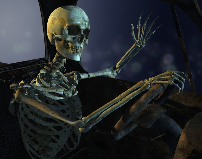 Skeleton driving a car at night