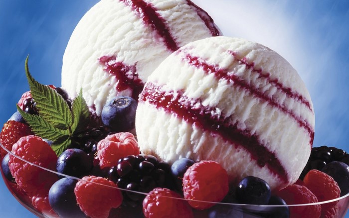Vanilla ice cream scoops with berry swirl and fresh berries