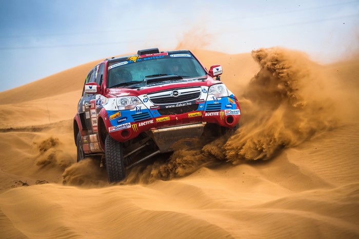 2012 Opel Antara Dakar rally car driving through sand