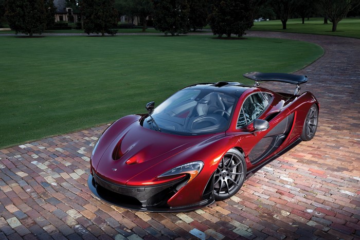 Red McLaren P1 on a brick driveway