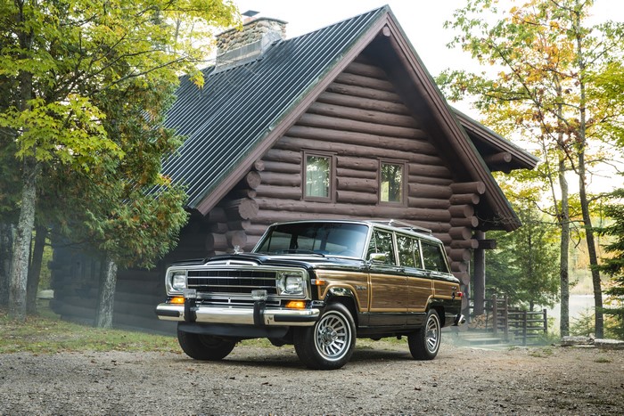 4K Retro Jeep in front of a log cabin