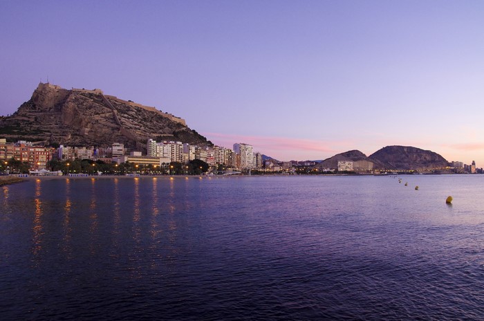 Alicante, Spain cityscape at dusk with castle and sea