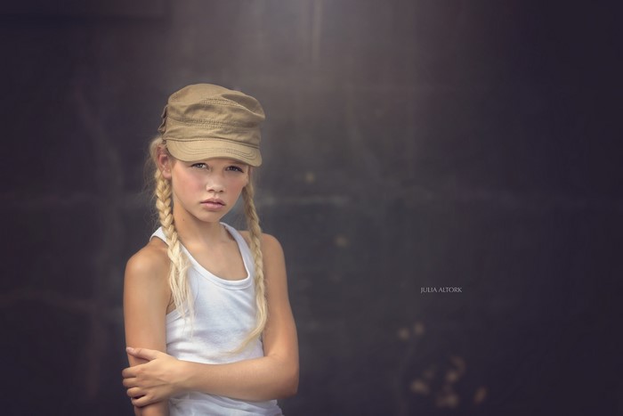 Girl with braids and baseball cap