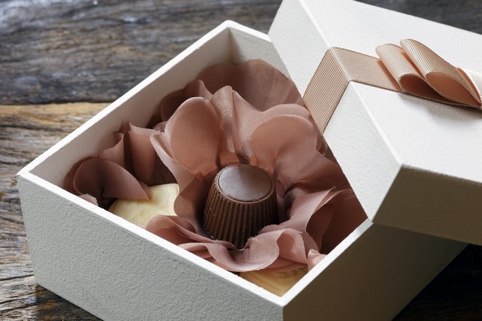 Chocolate candies in a gift box with ribbon