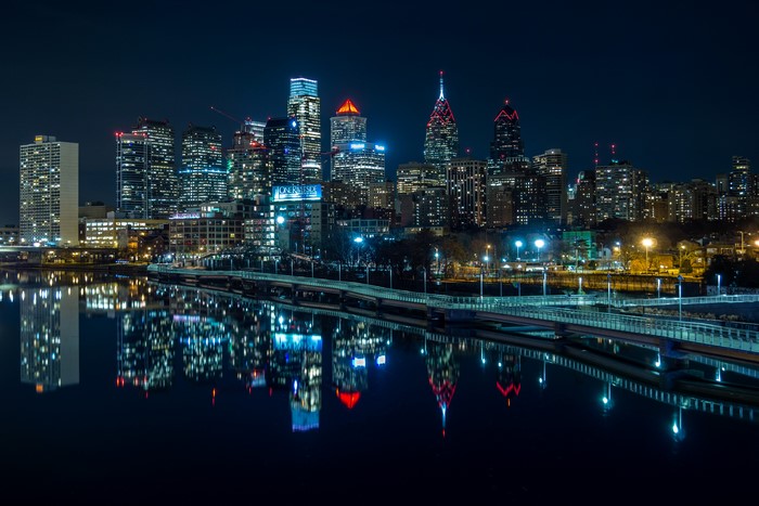 Philadelphia skyline reflected in river at night