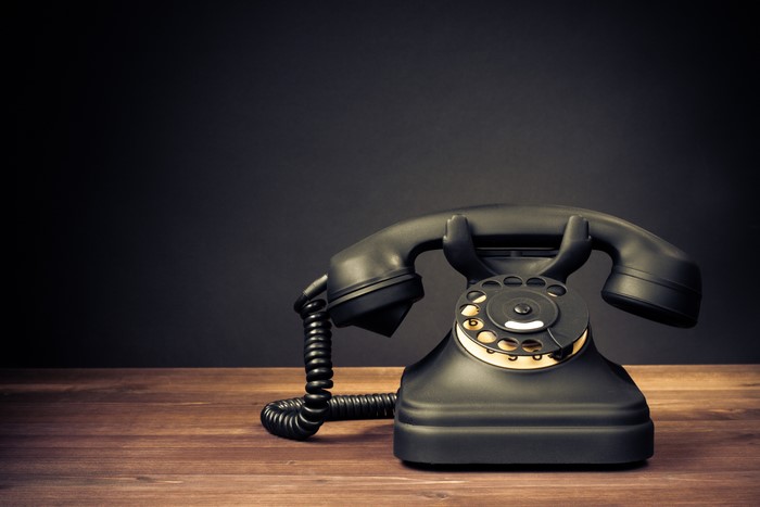 Retro rotary telephone on a wooden table
