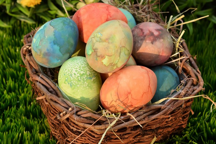 Easter eggs in a basket on grass