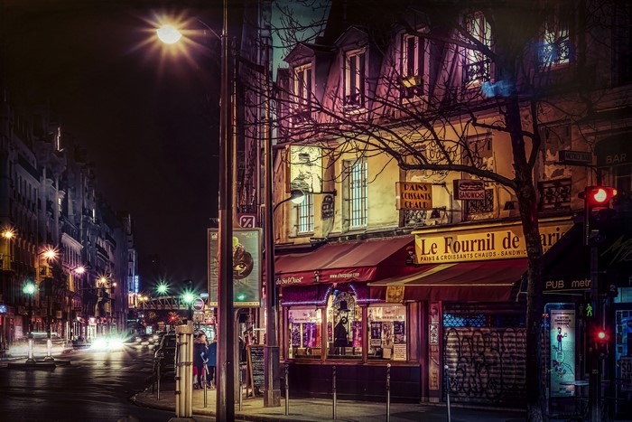 Paris street at night with Le Fournil de Paris bakery