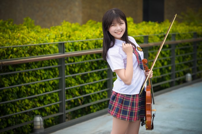 Asian girl in school uniform with violin