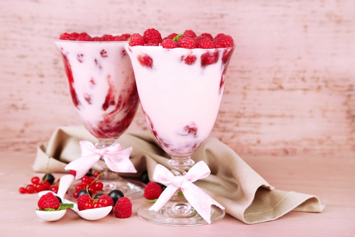 Two glasses of raspberry yogurt with berries