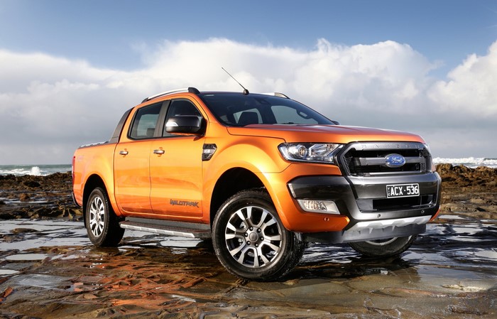 Orange Ford Ranger Wildtrak on rocky shore