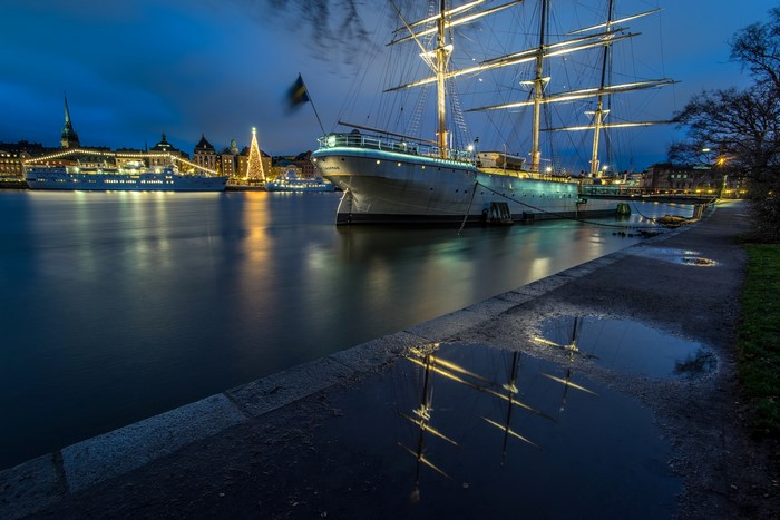 Tall ship docked in Stockholm harbor at night