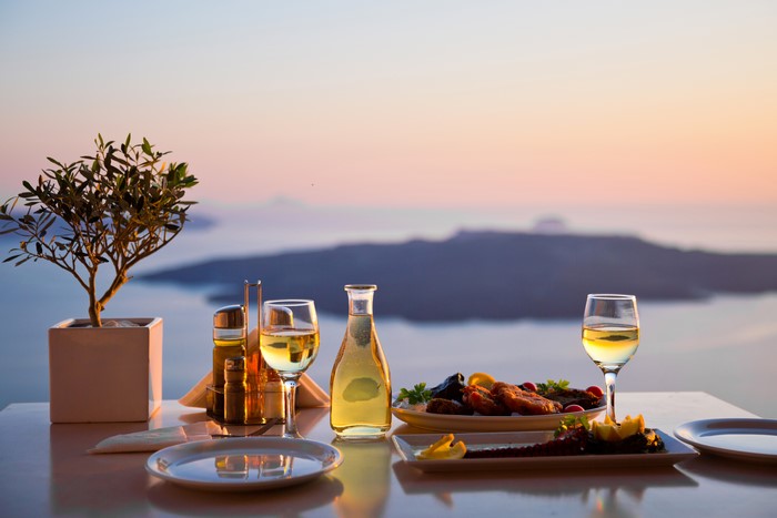 Table setting with food and wine at sunset