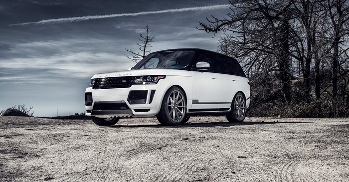 White Land Rover Vogue SUV on a dirt road