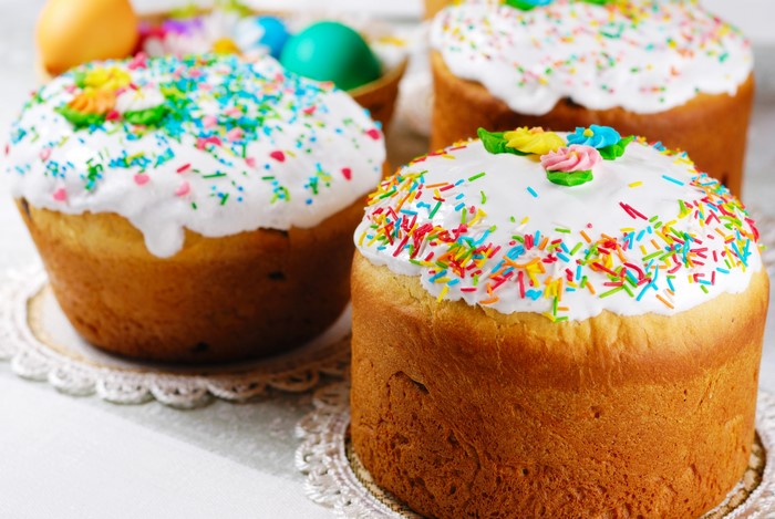 Easter Kulich cakes with icing and sprinkles