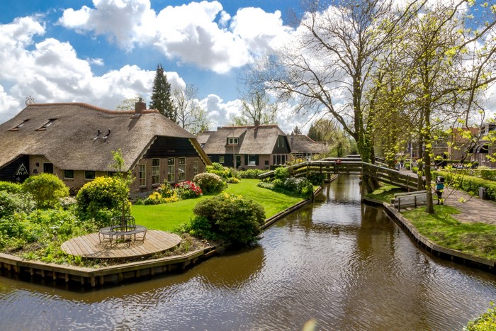 Giethoorn Netherlands canal with thatched roof houses and bridges