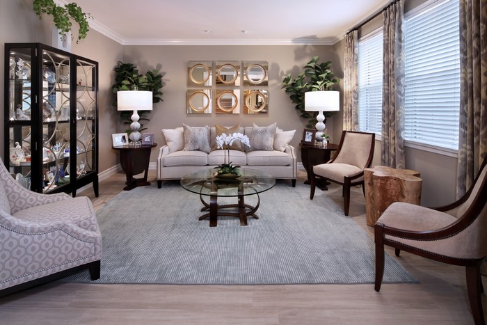 Living room with sofa, armchairs, and lamps