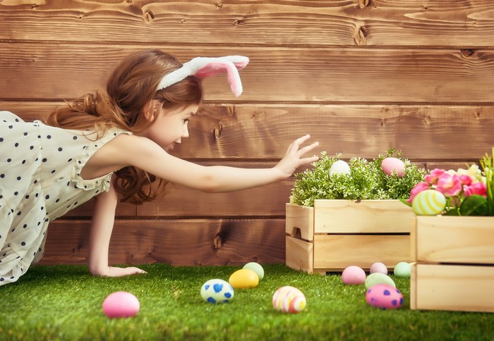 Girl with Easter Bunny Ears Hunting for Eggs