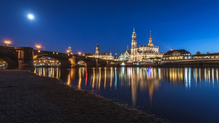 Dresden skyline with bridge and river at night